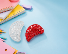 Curved barrette hair clips in red and clear finishes